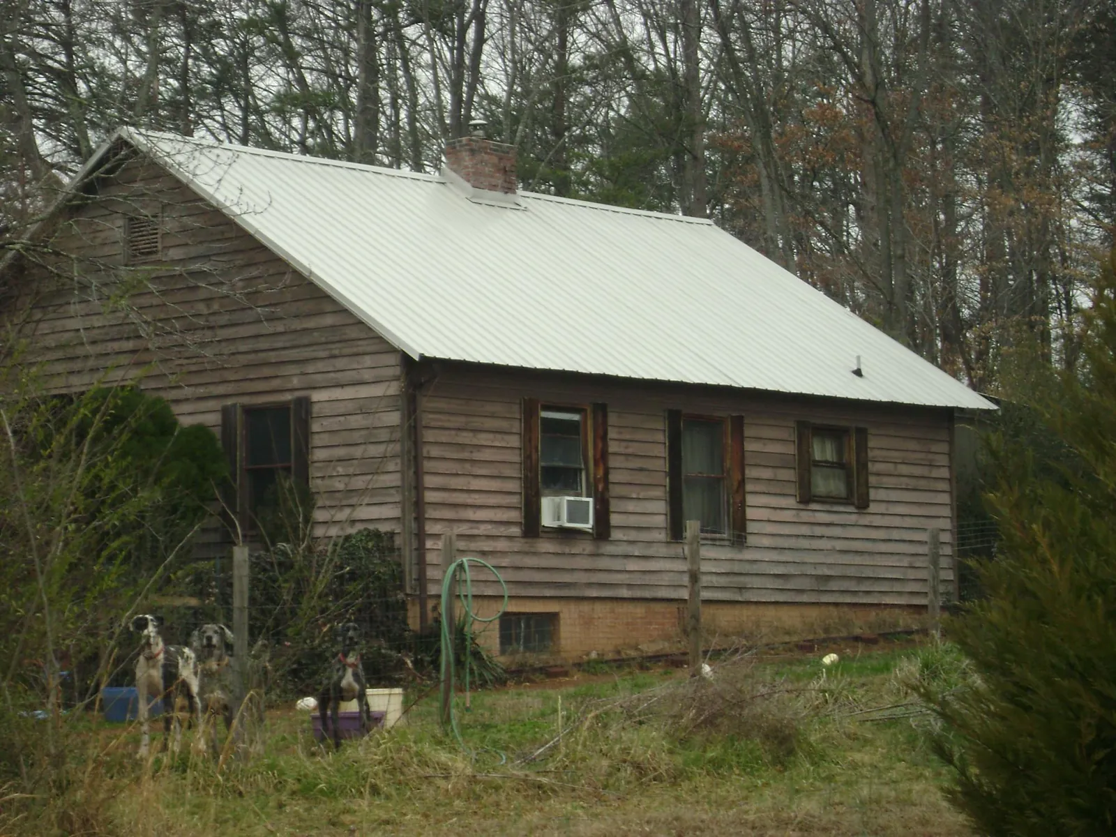 White metal roof on an old wood sided farmhouse, from a Metal Roof Installation job in Carpinteria